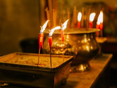 Incense sticks and soft lighting in a room.